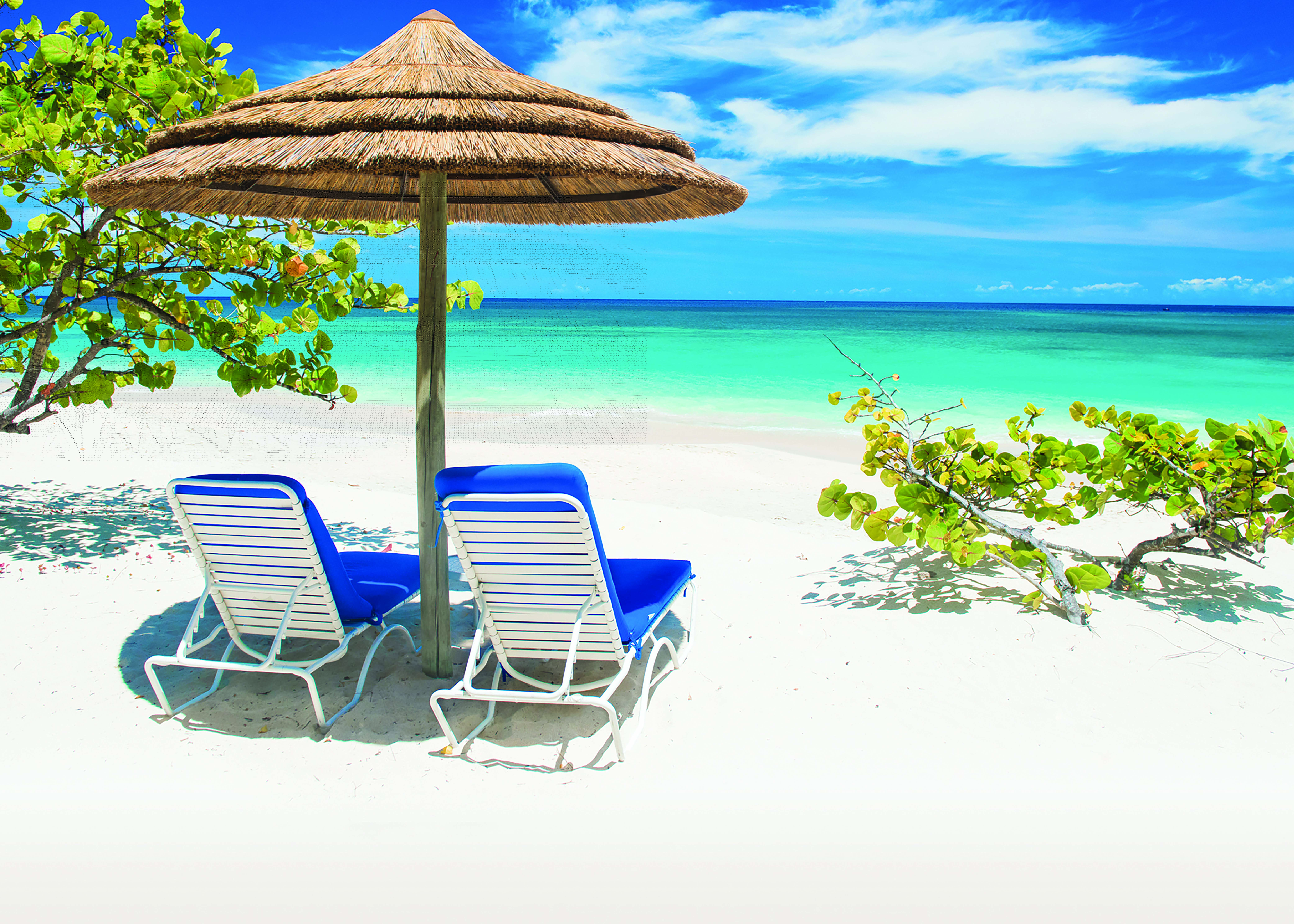 Spice Island Grenada sun loungers on the beach in the shade of a beach umbrella