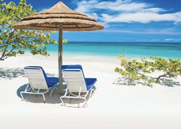 Spice Island Grenada sun loungers on the beach in the shade of a beach umbrella