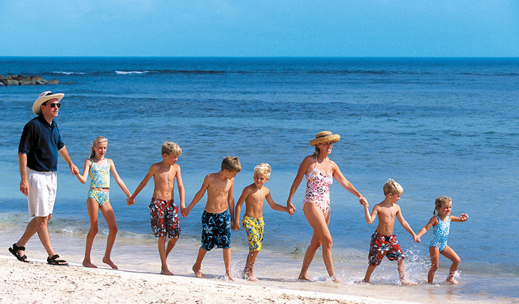 Half Moon Jamaica family walking on beach white sand