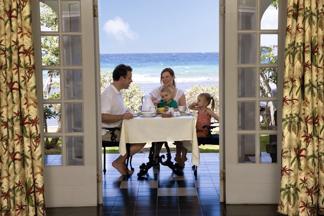Half Moon Jamaica family enjoying breakfast on terrace sea in background