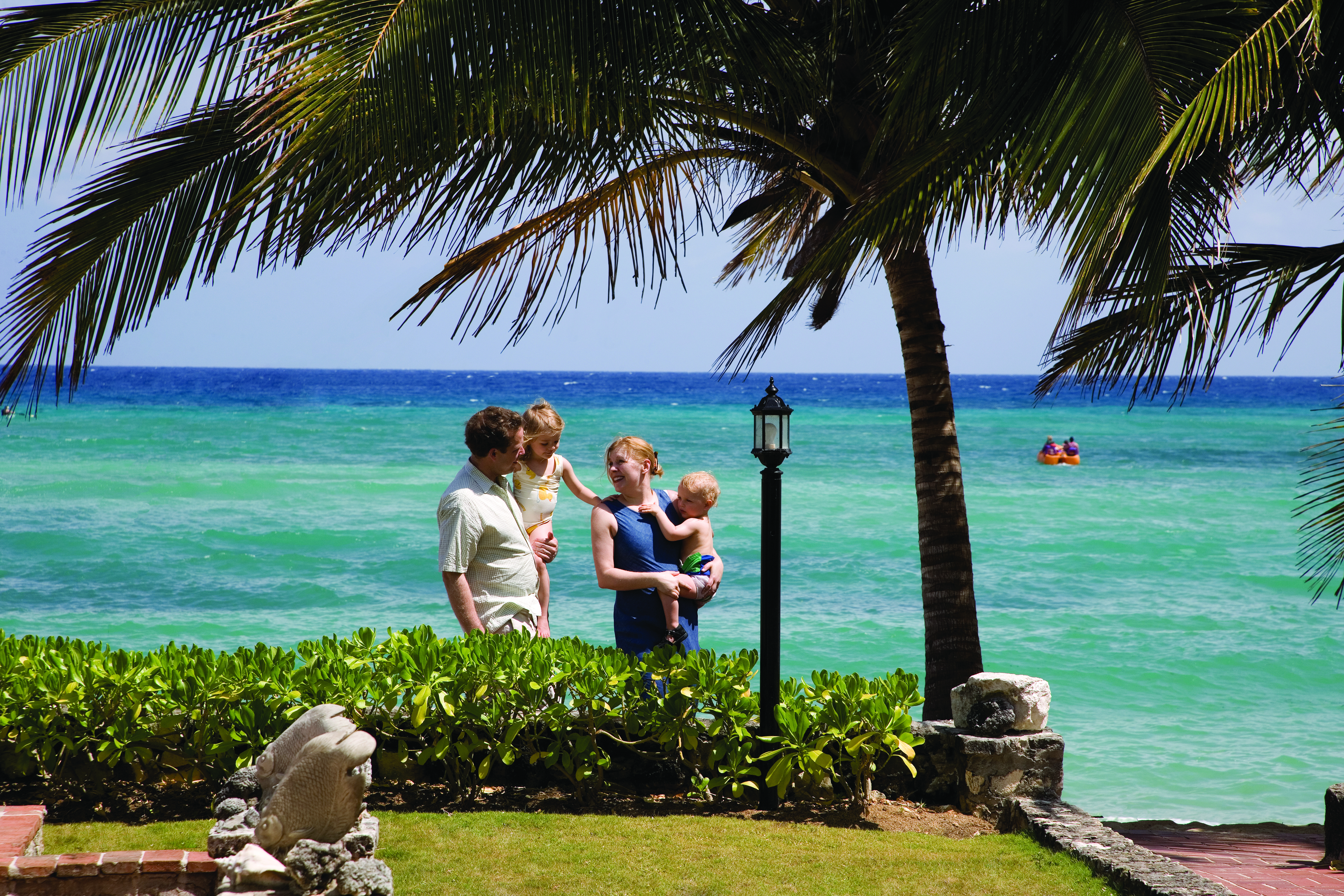 Half Moon Jamaica family walking along the sea front