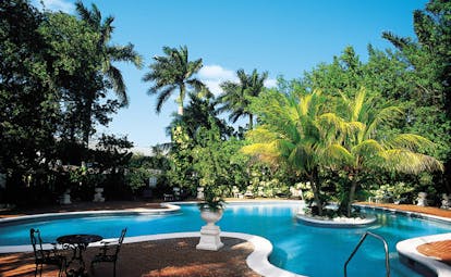 Half Moon Jamaica pool trees surrounding pool terrace sitting area