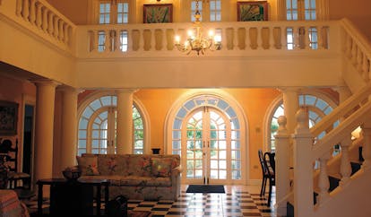 Half Moon Jamaica villa entrance hall sofa stairs tiles colonial décor
