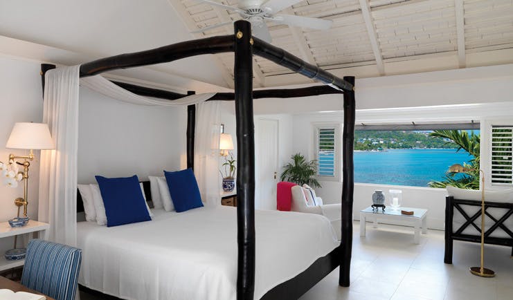 Round Hill Jamaica oceanfront bedroom four poster bed window opening out to ocean views