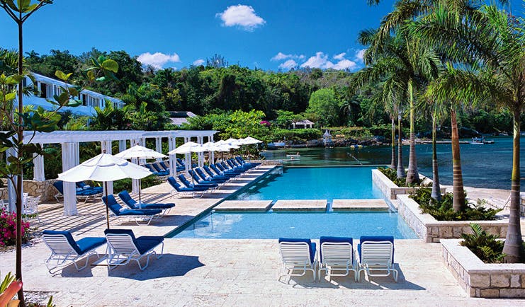Round Hill Jamaica pool sun loungers and umbrellas views of the ocean