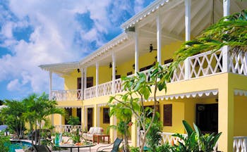 Four Seasons Nevis exterior yellow building greenery pool