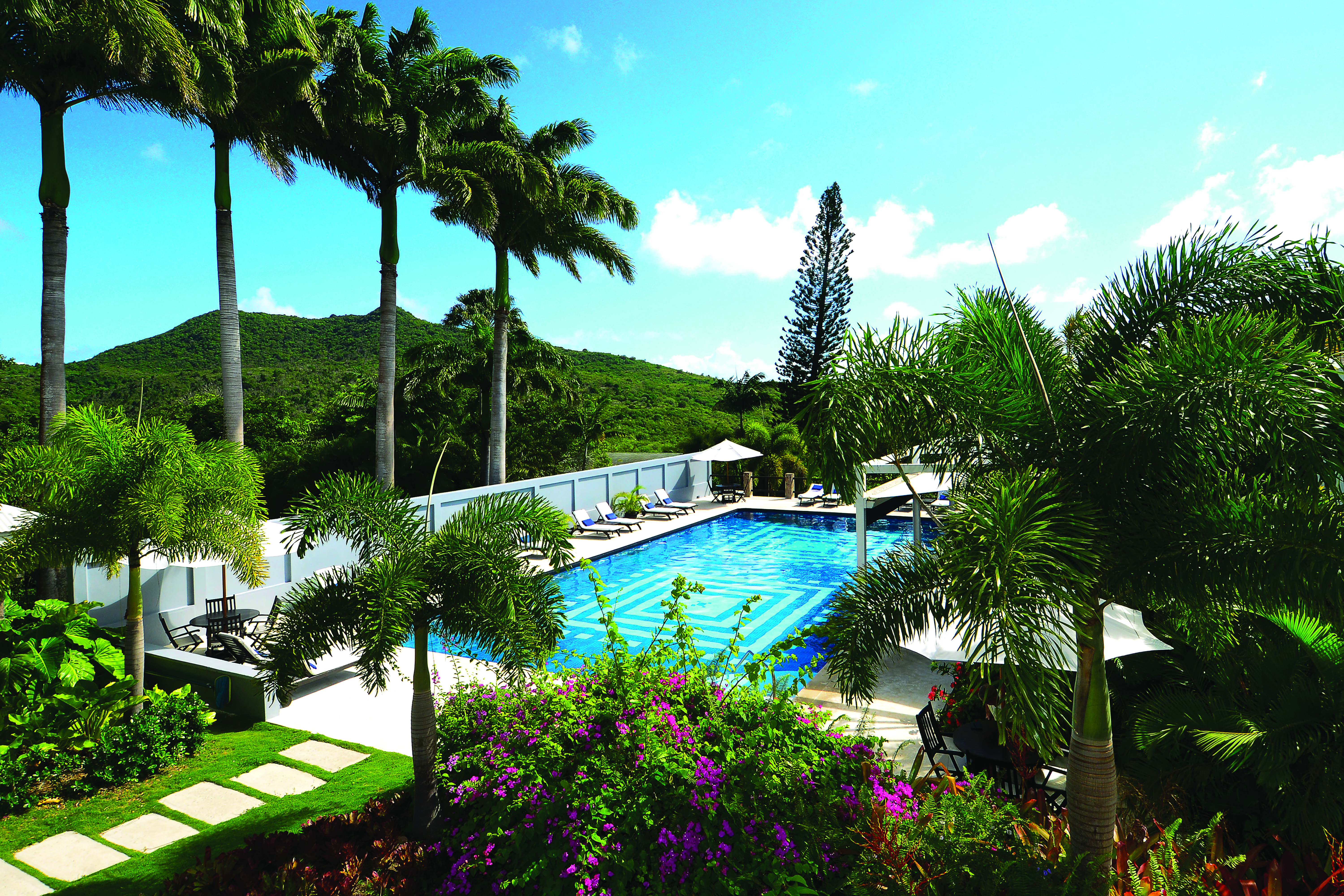 Montpelier Plantation Nevis gardens pink flowers and shrubbery pool in the background