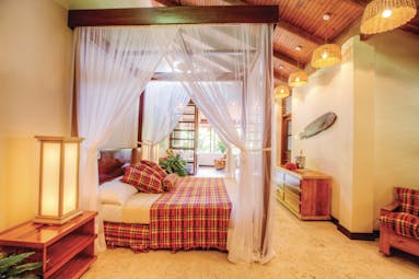 Anse Chastanet St Lucia deluxe beach suite canopied four poster bed lounge area