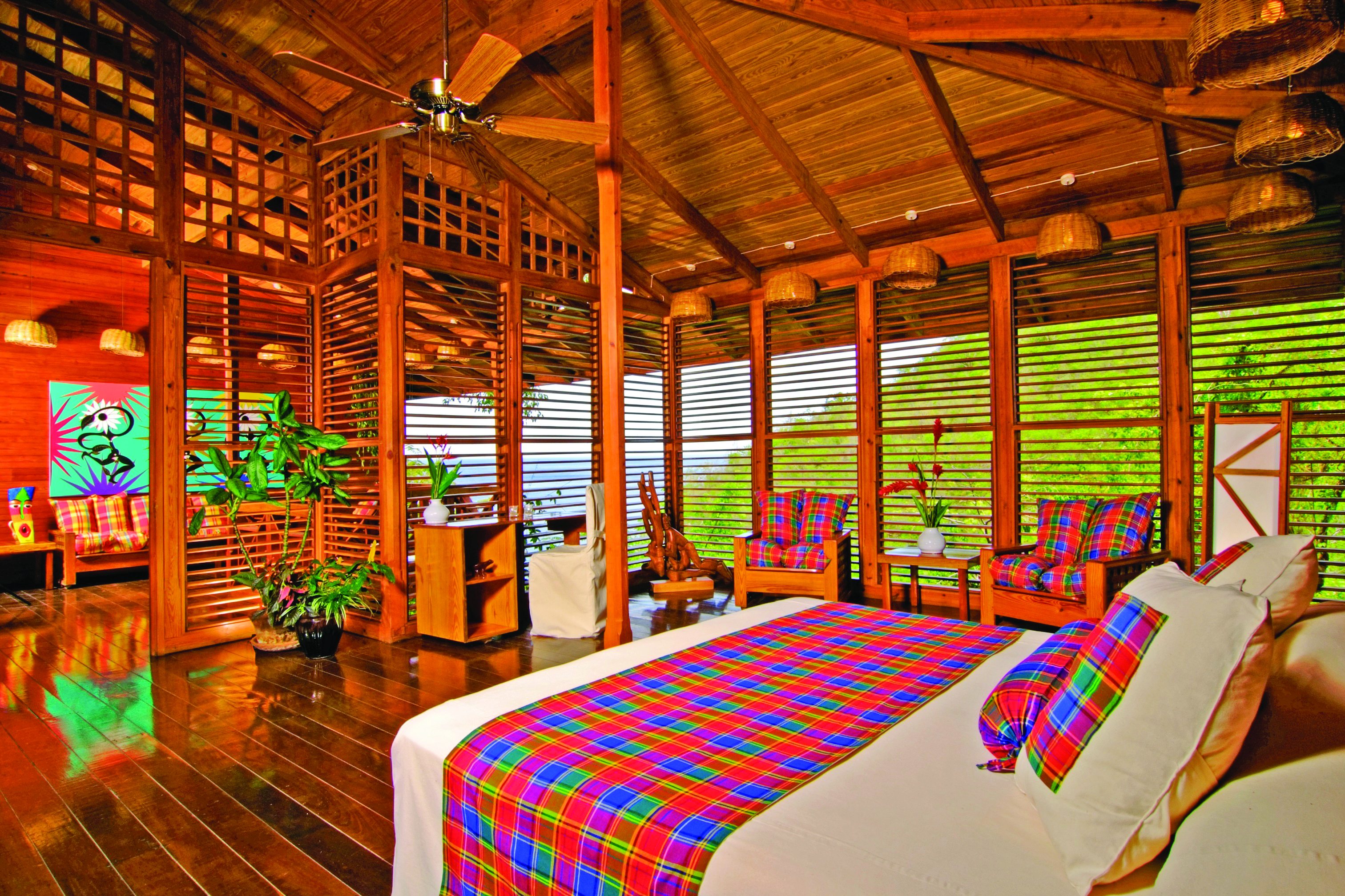 Anse Chastanet St Lucia deluxe hill suite king size bed wooden louvre walls hillside and ocean views