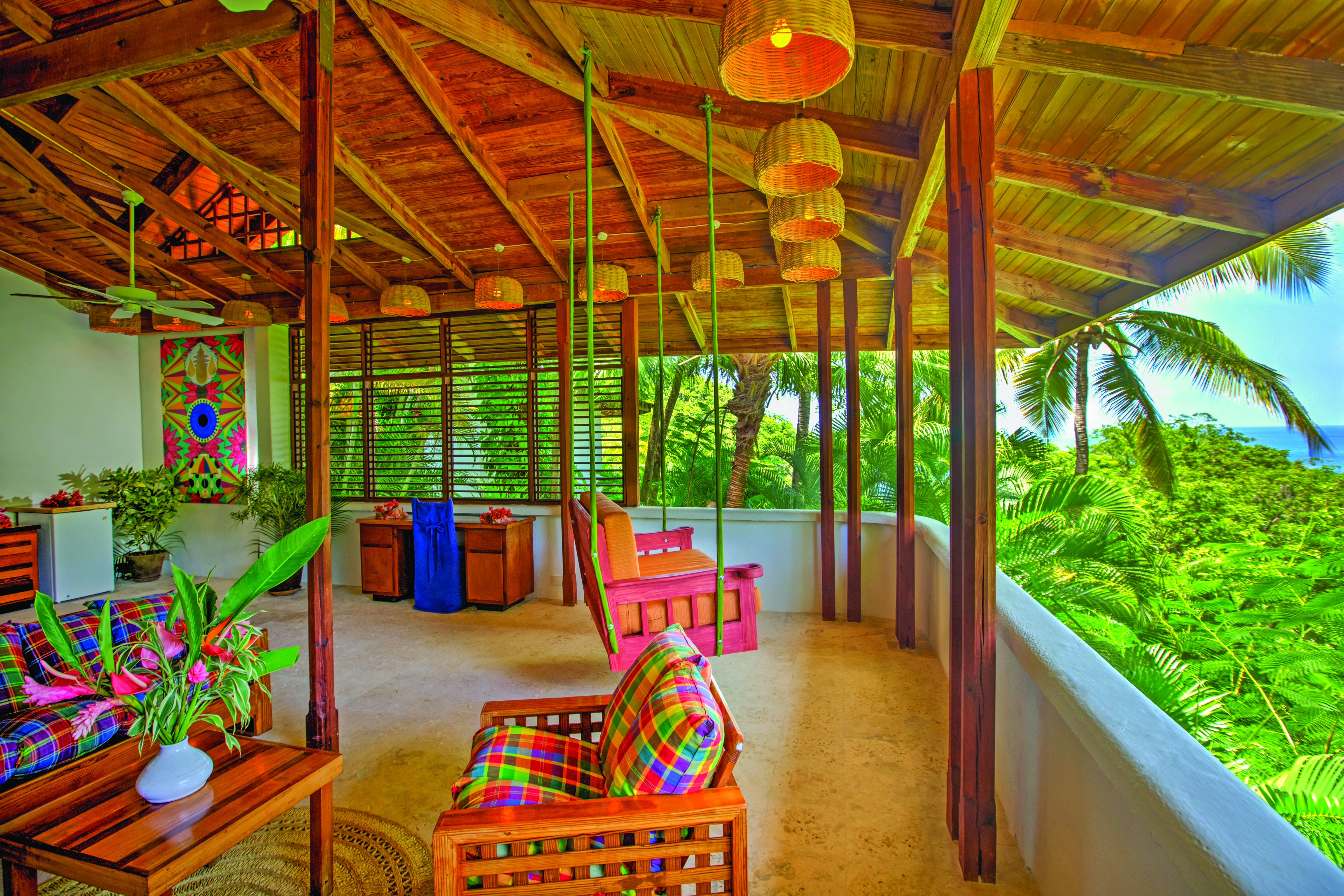 Anse Chastanet St Lucia deluxe hill terrace swinging chair and seating area overlooking hillside and ocean