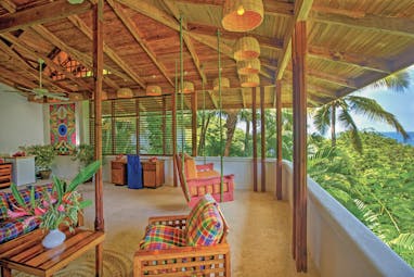 Anse Chastanet St Lucia deluxe hill terrace swinging chair and seating area overlooking hillside and ocean