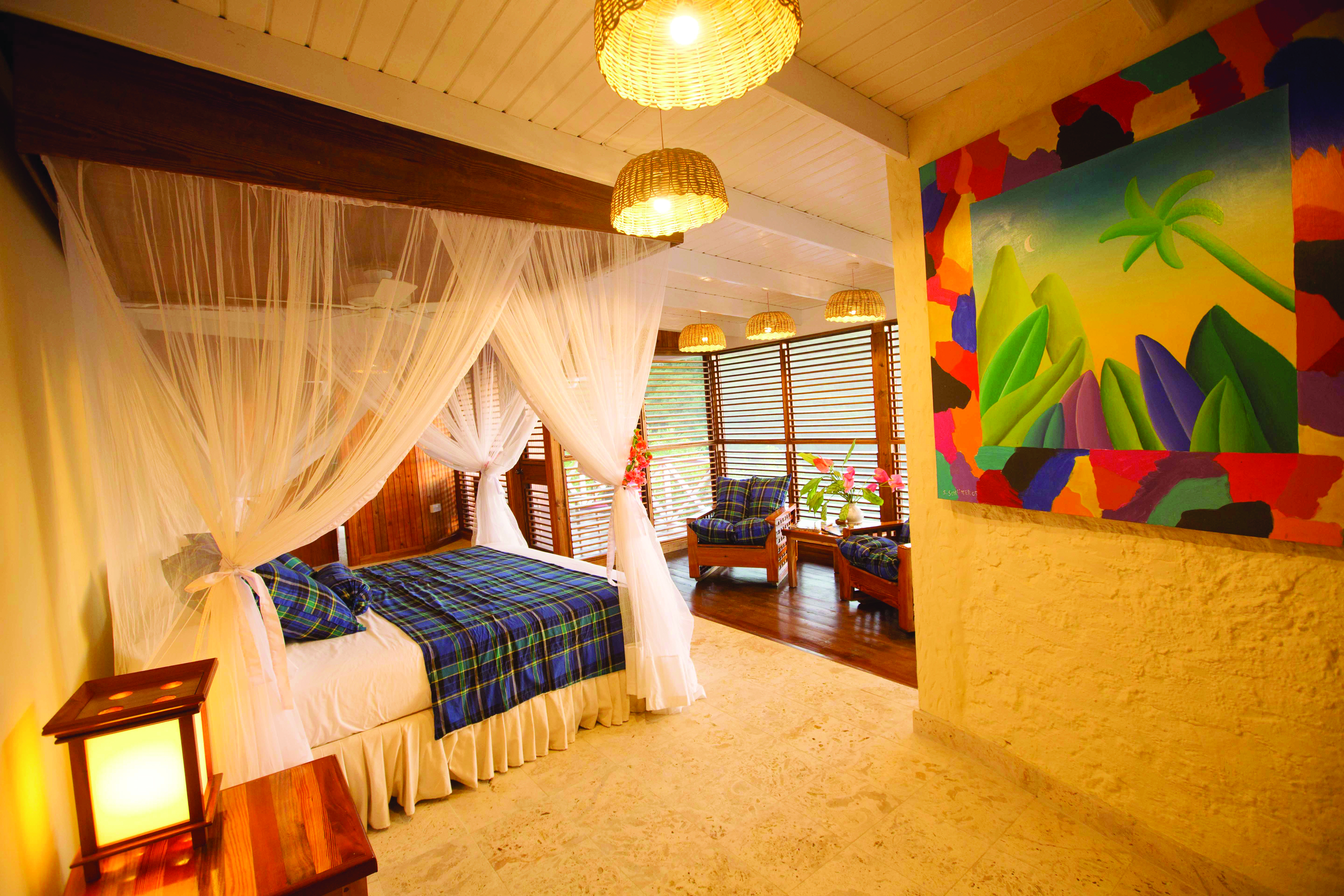 Anse Chastanet St Lucia standard room canopied king size bed armchairs and coffee table