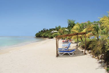 Calabash Cove St Lucia sandy beach clear ocean water sun loungers