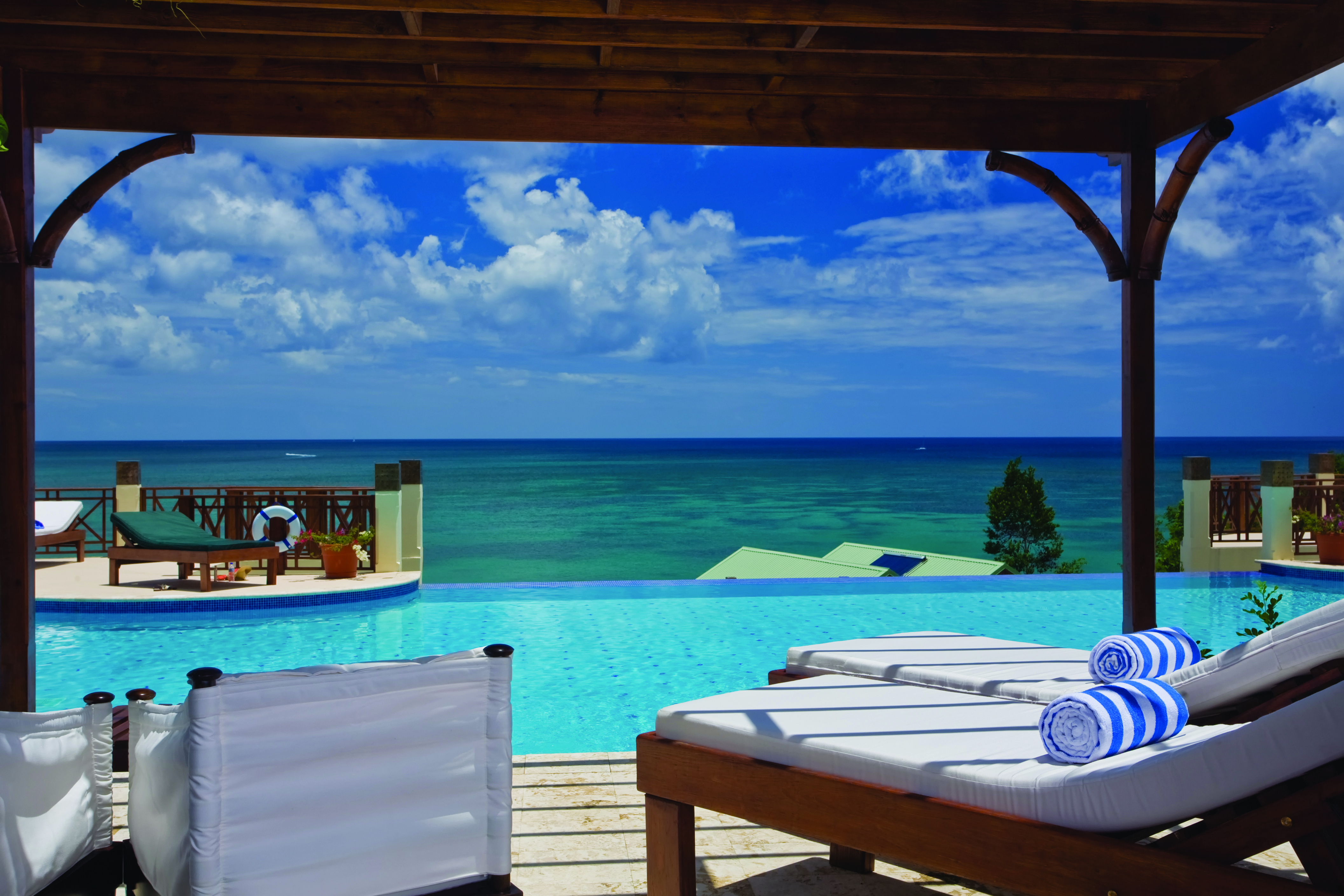 Calabash Cove St Lucia swim up junior suite terrace lounge chairs infinity pool overlooking the ocean
