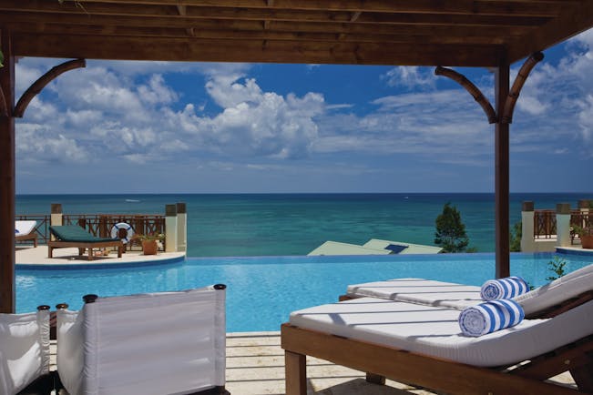 Calabash Cove St Lucia swim up junior suite terrace lounge chairs infinity pool overlooking the ocean