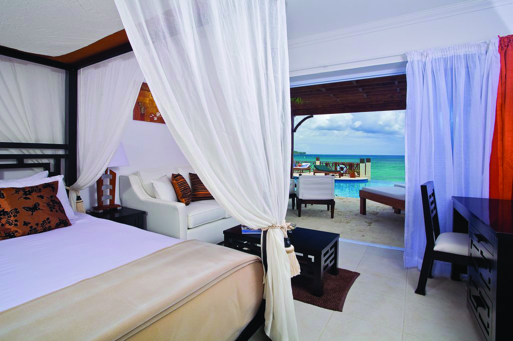 Calabash Cove St Lucia junior suite bed and living area doors opening up to terrace with private rooms