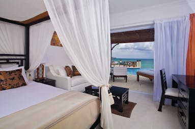 Calabash Cove St Lucia junior suite bed and living area doors opening up to terrace with private rooms