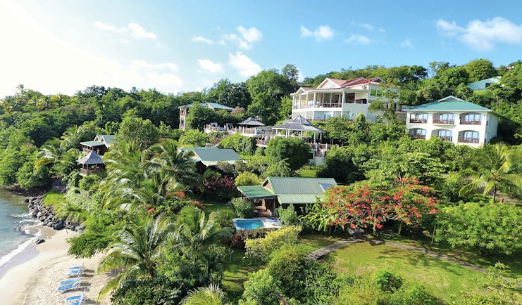 Calabash Cove St Lucia resort hotel buildings over looking the beach lawns and trees