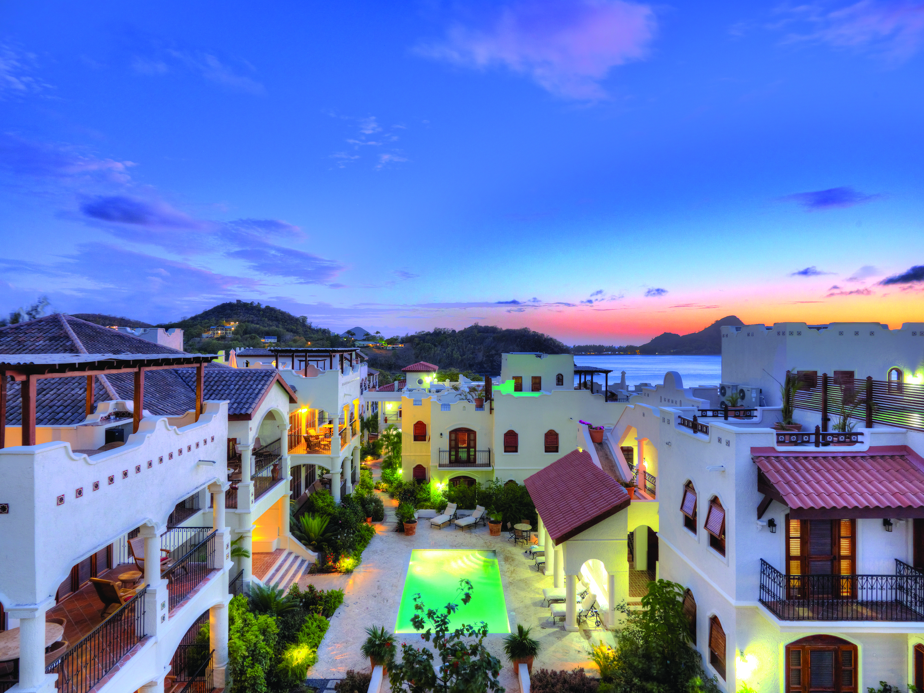 Cap Maison St Lucia villa courtyard overlooking pool at sunset