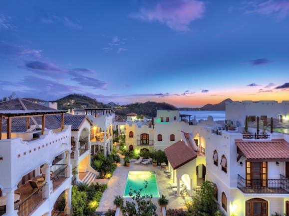 Cap Maison St Lucia villa courtyard overlooking pool at sunset