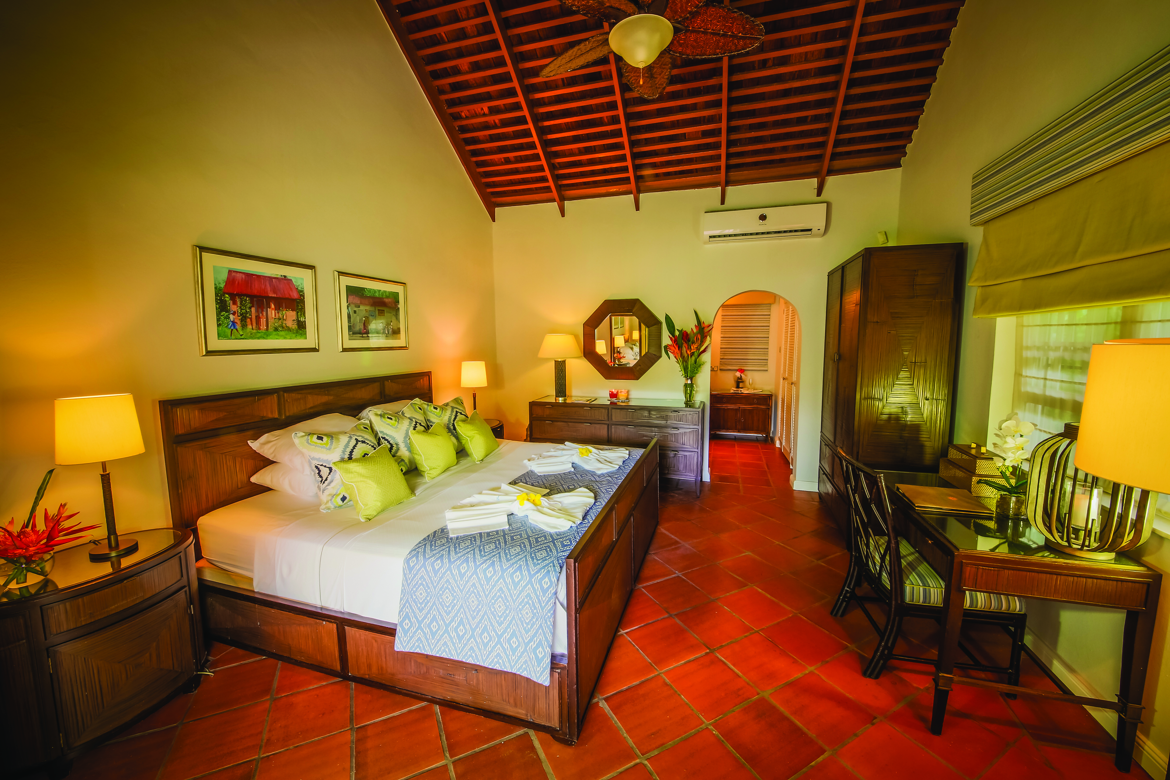 East Winds Inn St Lucia deluxe cottage bedroom bed and bedroom furniture en suite bathroom