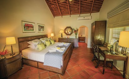 East Winds Inn St Lucia deluxe cottage bedroom bed and bedroom furniture en suite bathroom