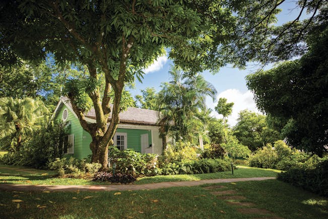 East Winds Inn St Lucia deluxe cottage exterior lawns trees and greenery