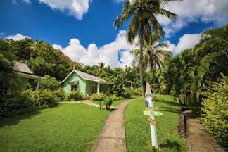 East Winds Inn St Lucia deluxe cottage path across the lawn surrounded by greenery