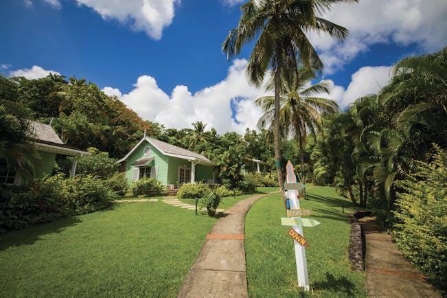 East Winds Inn St Lucia deluxe cottage path across the lawn surrounded by greenery