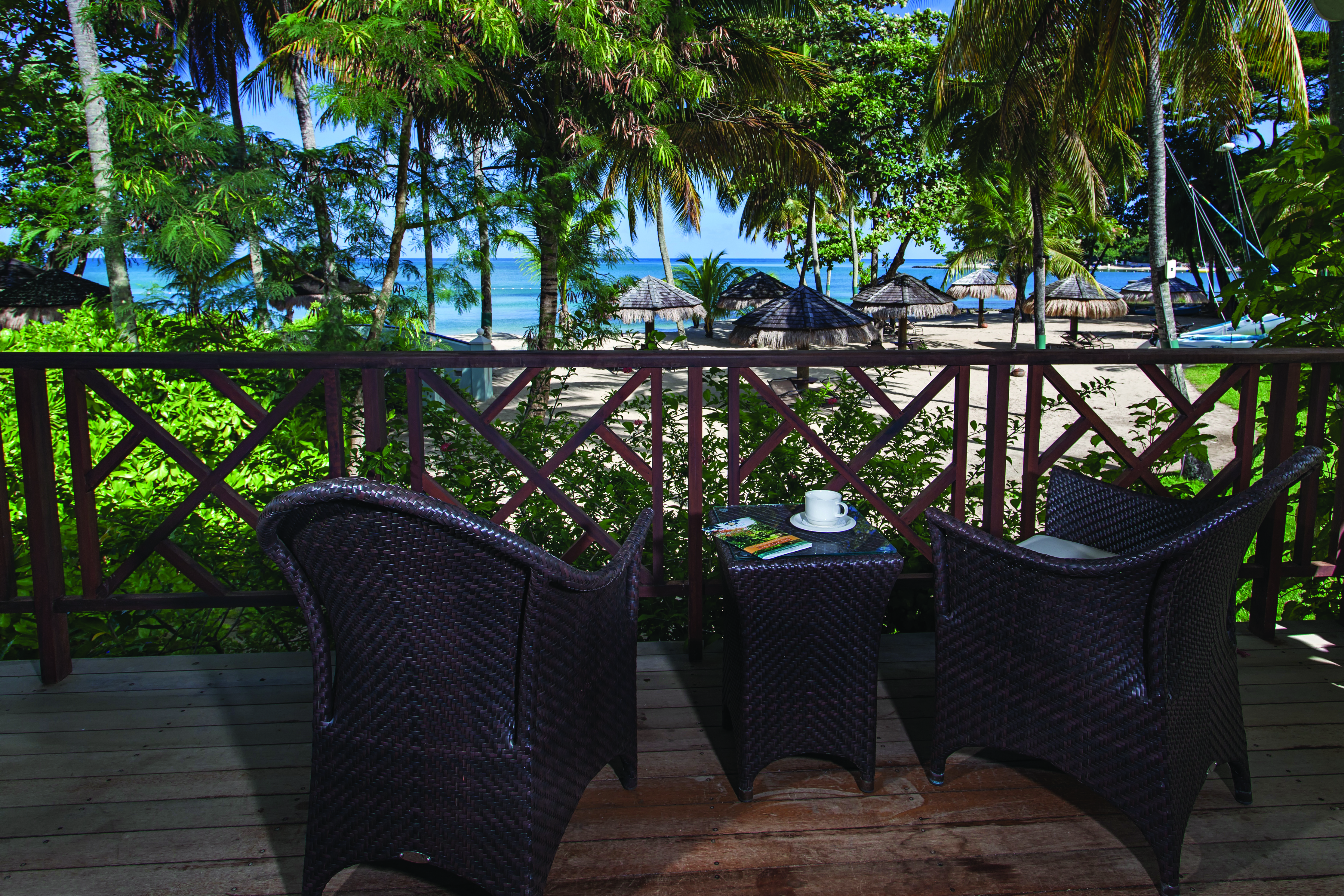 East Winds Inn St Lucia ocean view terrace outside seating area with views of beach and ocean