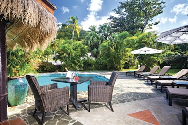 East Winds Inn St Lucia poolside seating sun loungers table and chairs