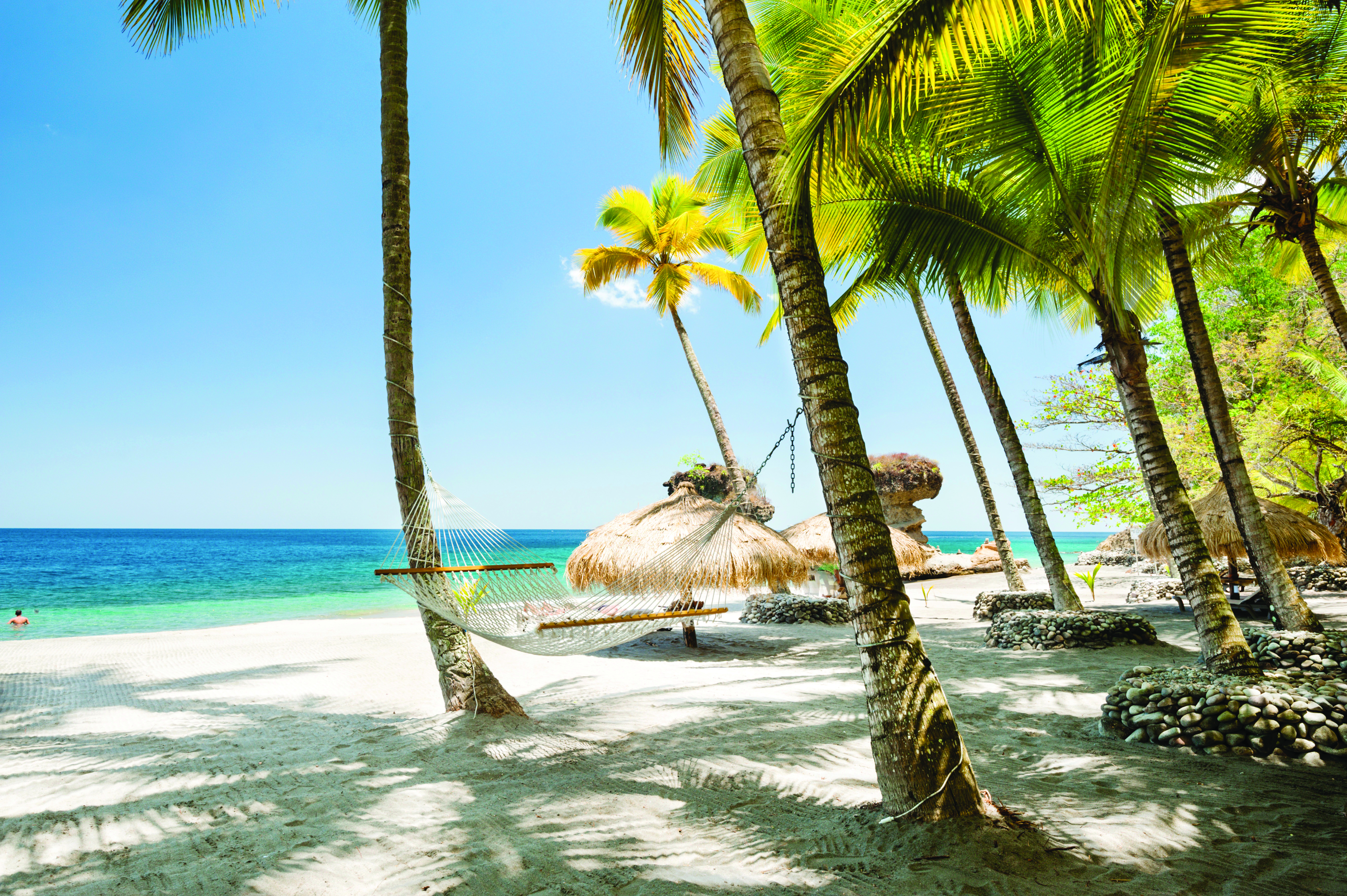 Jade Mountain St Lucia hammock tied between two palm trees on the beach