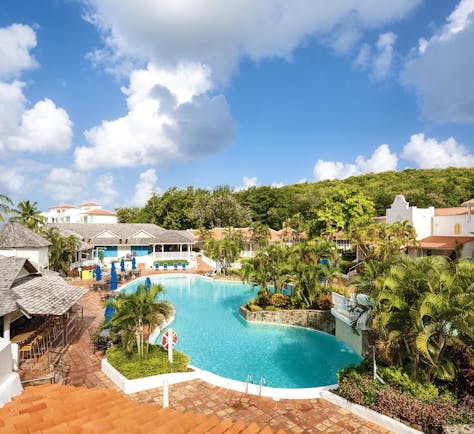 Windjammer Landing St Lucia pool with outdoor seating areas and palm trees