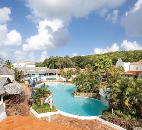Windjammer Landing St Lucia pool with outdoor seating areas and palm trees