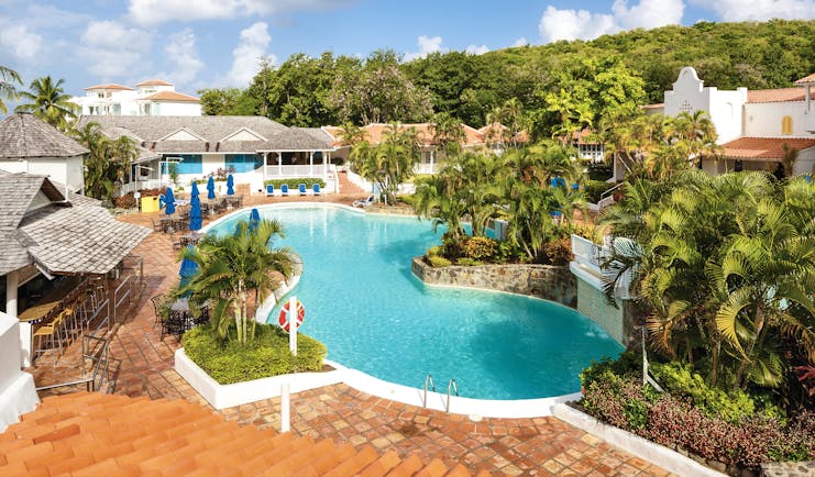 Windjammer Landing St Lucia pool with outdoor seating areas and palm trees