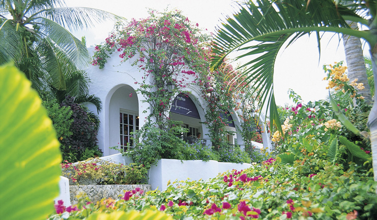 La Samanna St Martin exterior white building archway gardens pink flowers