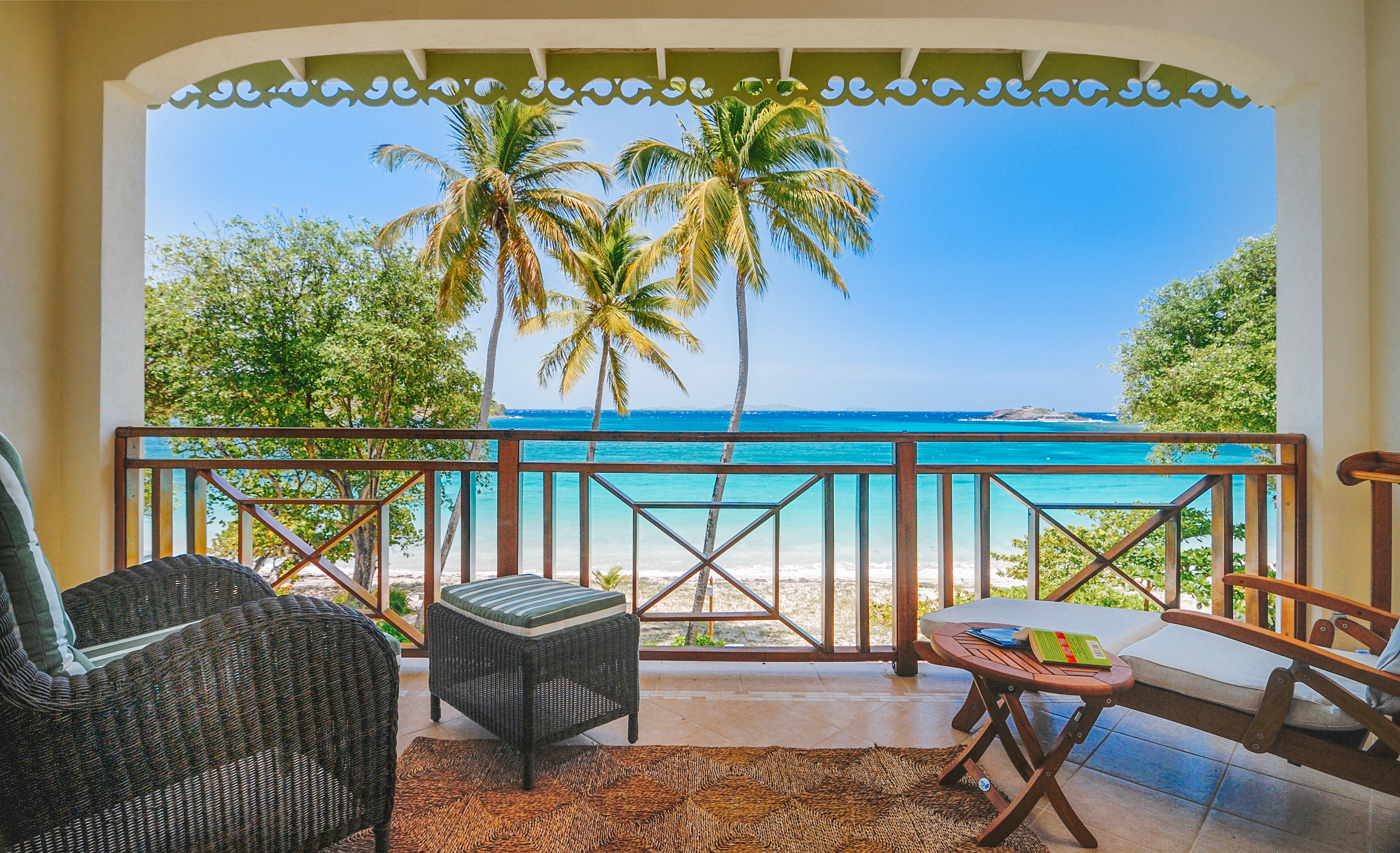 Bequia Beach Hotel balcony, armchair, sun lounger, overlooking beach with white sands and bright blue sea