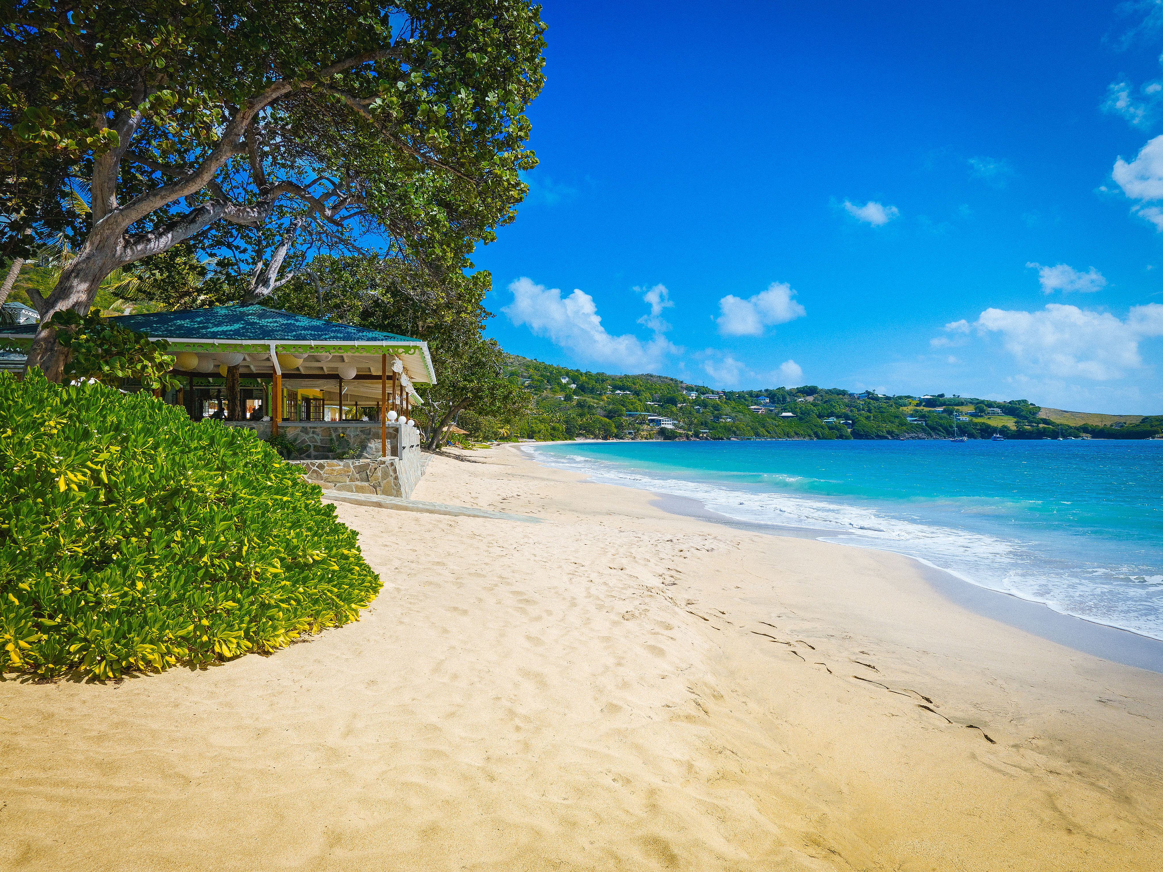 Bequia Beach Hotel Beach, golden sands, bright blue sea, trees and greenery