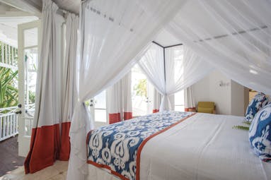 Cotton House St Vincent and the Grenadines bedroom canopied king size bed doors opening to balcony