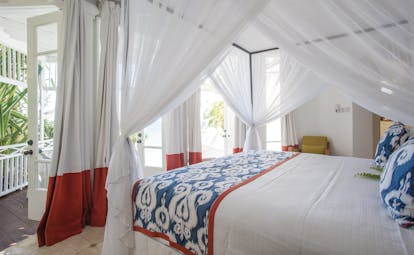 Cotton House St Vincent and the Grenadines bedroom canopied king size bed doors opening to balcony