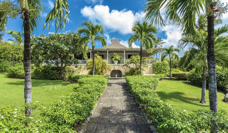 Cotton House St Vincent and the Grenadines path leading up to entrance lawns and palm trees