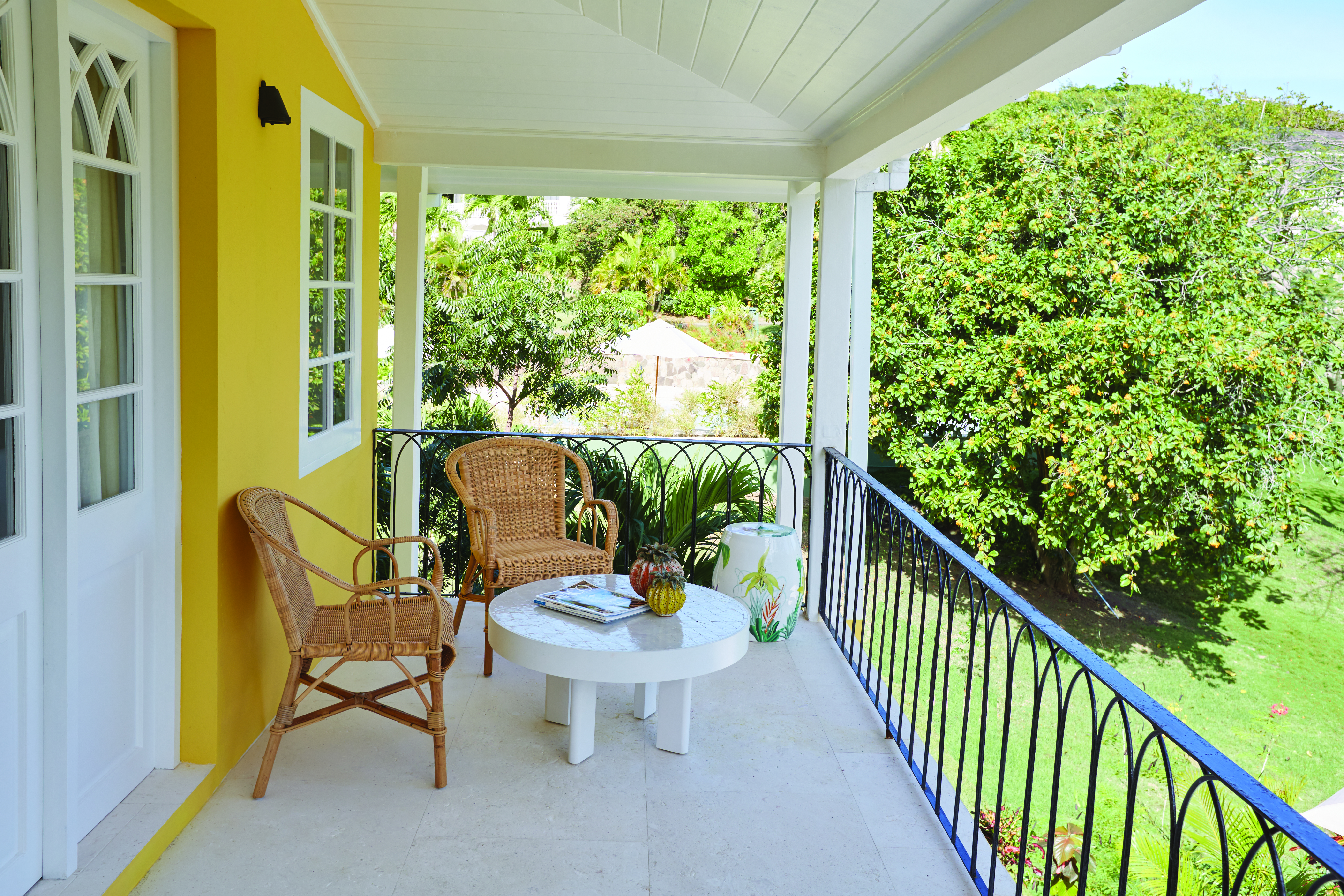 Cotton House St Vincent and the Grenadines villa balcony outdoor seating area overlooking lawns#
