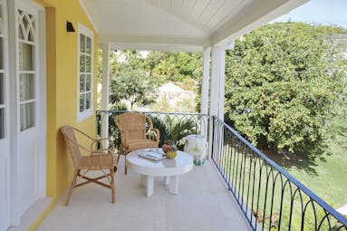 Cotton House St Vincent and the Grenadines villa balcony outdoor seating area overlooking lawns#