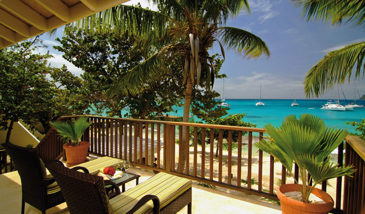 Palm Island St Vincent and the Grenadines island loft balcony sun loungers view of ocean boats on water