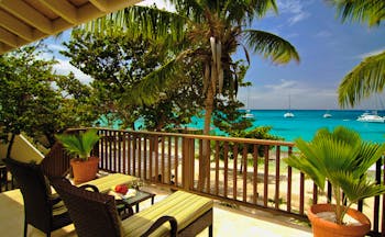 Palm Island St Vincent and the Grenadines island loft balcony sun loungers view of ocean boats on water