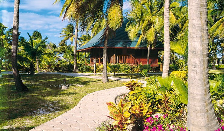 Palm Island St Vincent and the Grenadines loft exterior path through lawns and gardens palm trees 
