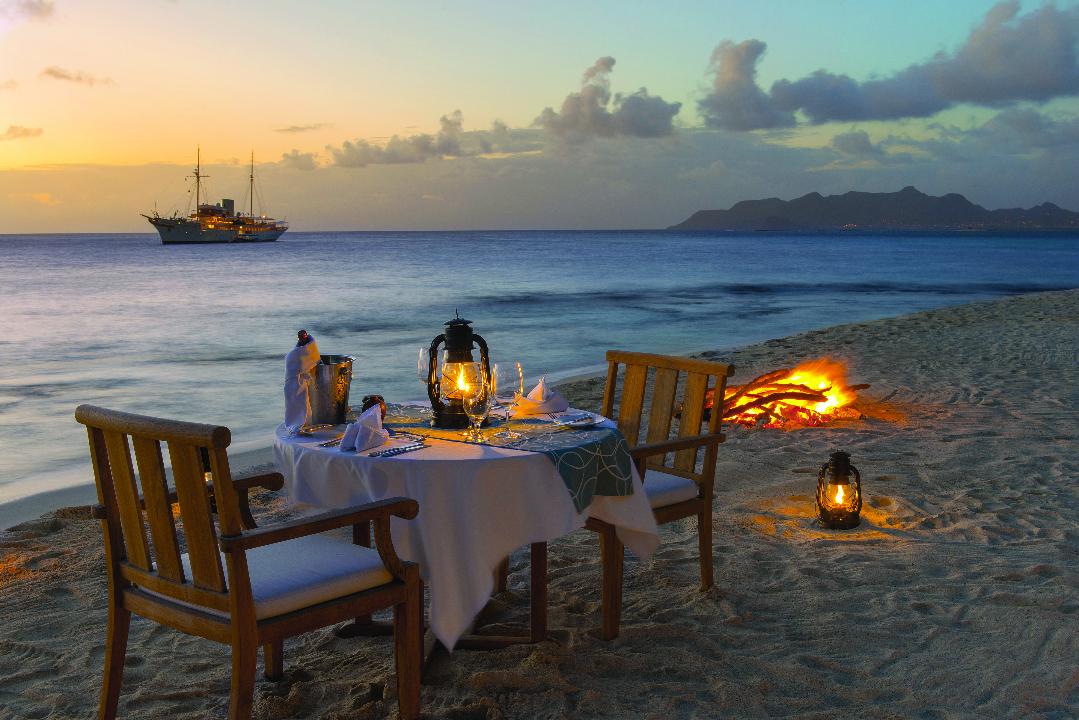 Petit St Vincent beach dining beach fire boat on the water