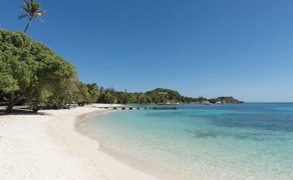 Petit St Vincent beach jetty white sandy beach clear blue ocean