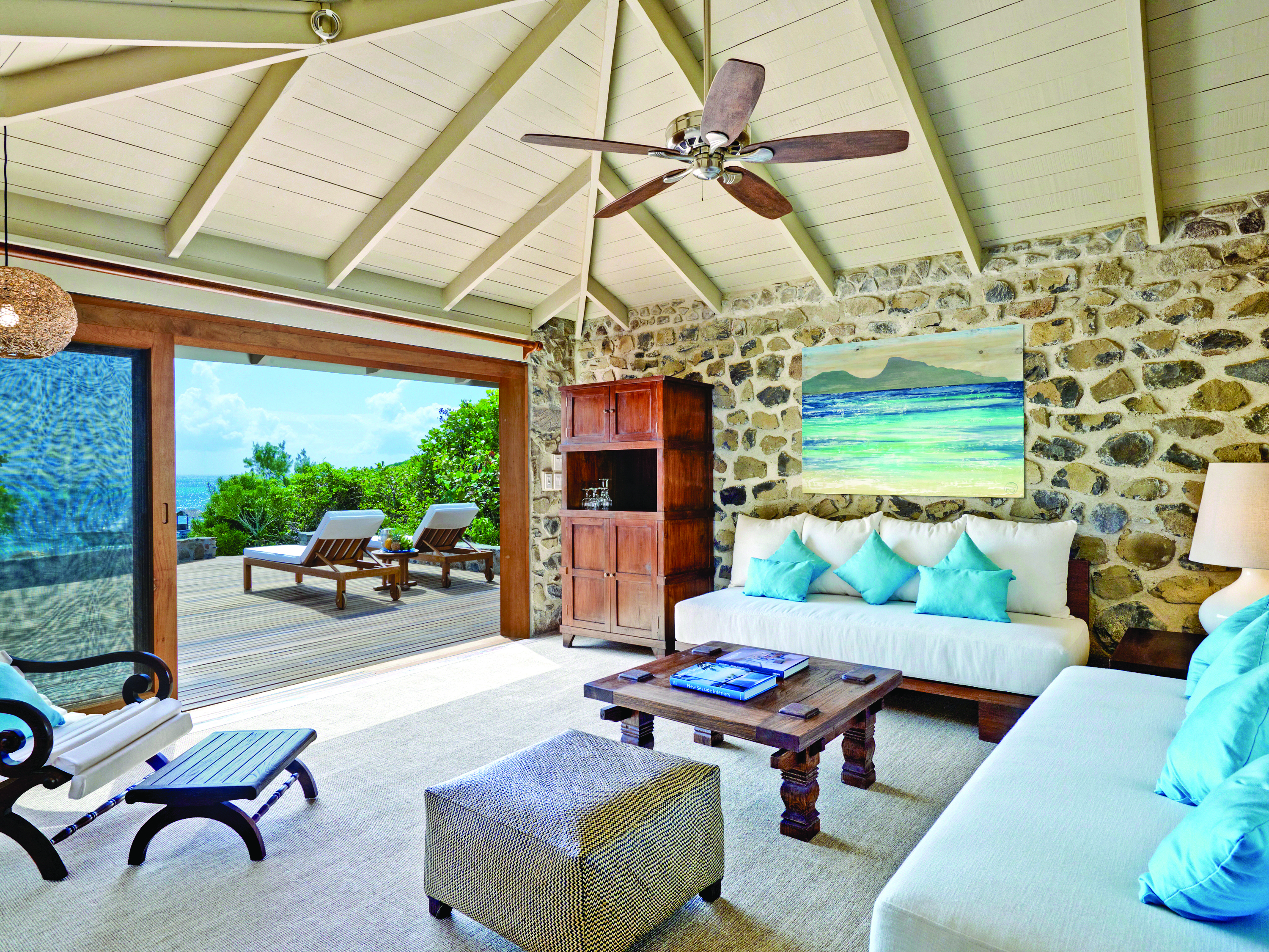 Petit St Vincent beach villa living area indoor seating decking lounger ocean views