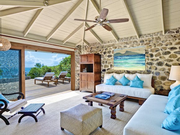 Petit St Vincent beach villa living area indoor seating decking lounger ocean views